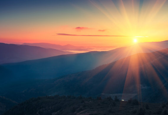 Panoramic view of  colorful sunrise in mountains. Filtered image:cross processed vintage effect.